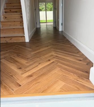 Hallway after: light oak herringbone flooring fitted by CTP